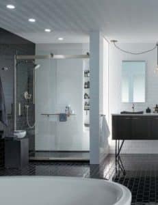 A Luxurious Bathroom With Dark Tile Floors and a Modern Walk-In Shower